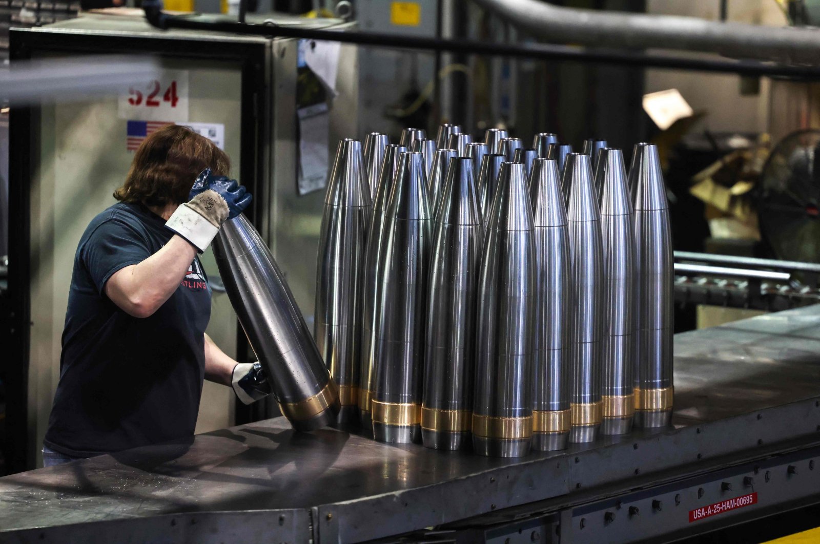 An employee handles 155 mm caliber shells after manufacturing at the Scranton Army Ammunition Plant (SCAAP) in Scranton, Pennsylvania, U.S., April 16, 2024. (AFP Photo)