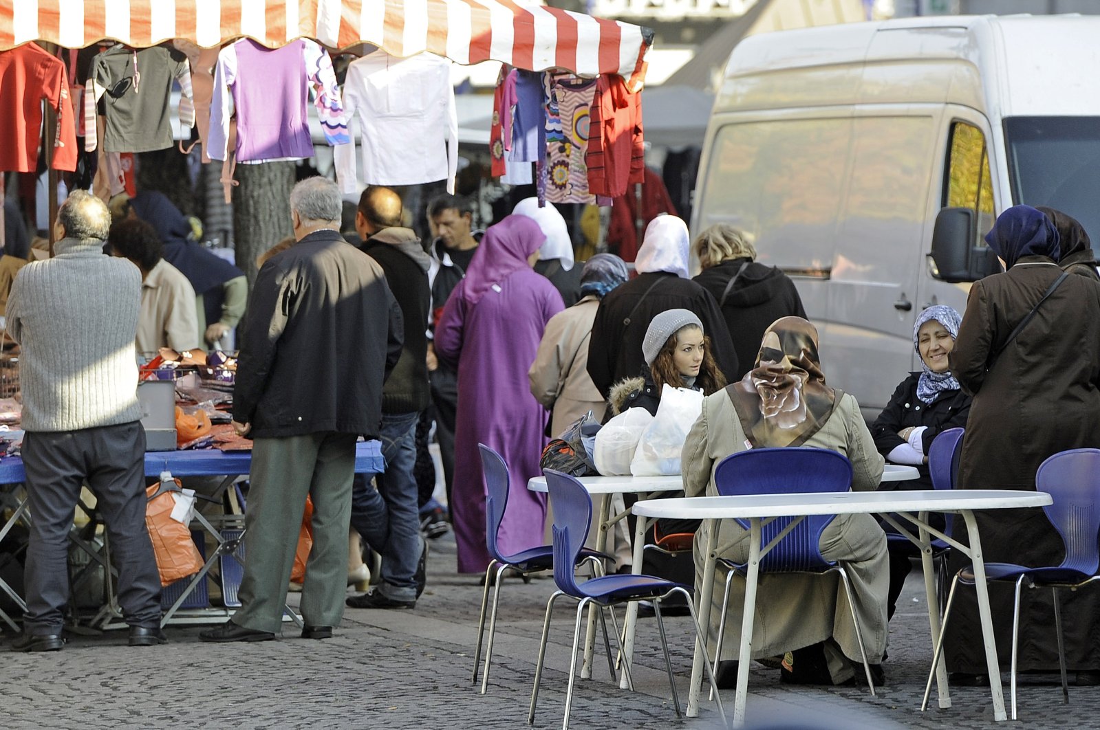 Turkish people sit at a market in the Turkish neighborhood in Duisburg-Marxloh, Germany, Oct. 31, 2011. (AP Photo)