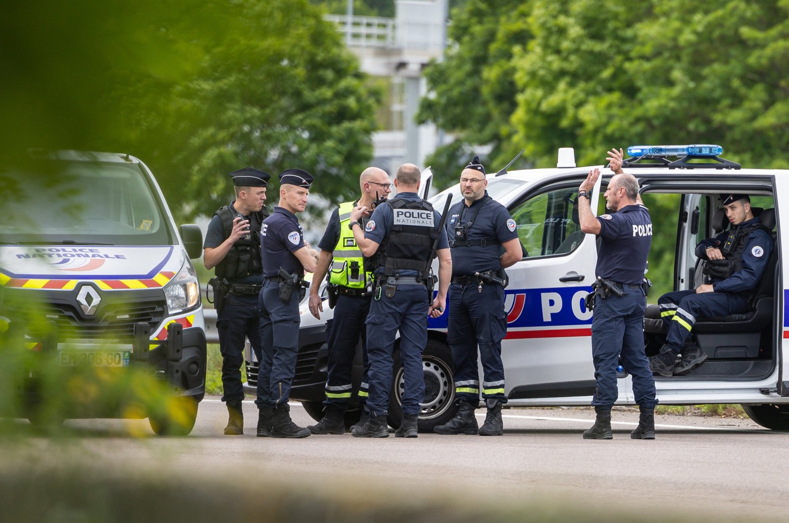 French police officers stand guard at the toll station of Incarville where gunmen ambushed a prison van, near Rouen, northern France, May 14, 2024. (EPA Photo)