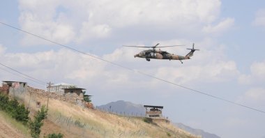 A Turkish Armed Forces (TSK) helicopter runs announcements for terrorists to surrender over mountains in Türkiye's Hakkari province bordering northern Iraq, Türkiye, Oct. 30, 2022. (DHA Photo)