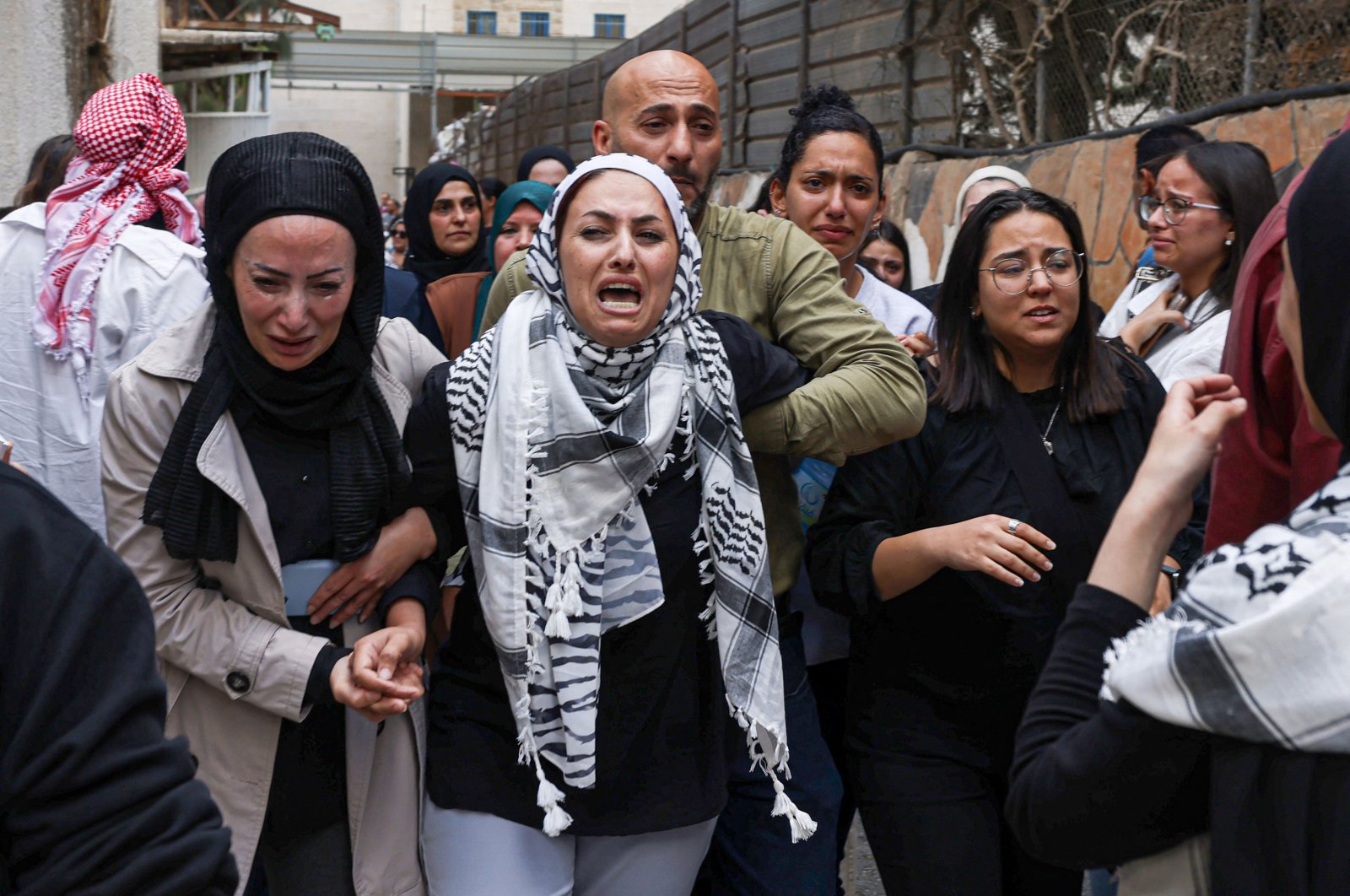 Mourners and relatives cry during the funeral of Palestinian Ayser Mohammad Safi who was killed by Israeli troops in Ramallah, occupied West Bank, Palestine, May 15, 2024. (AFP Photo)