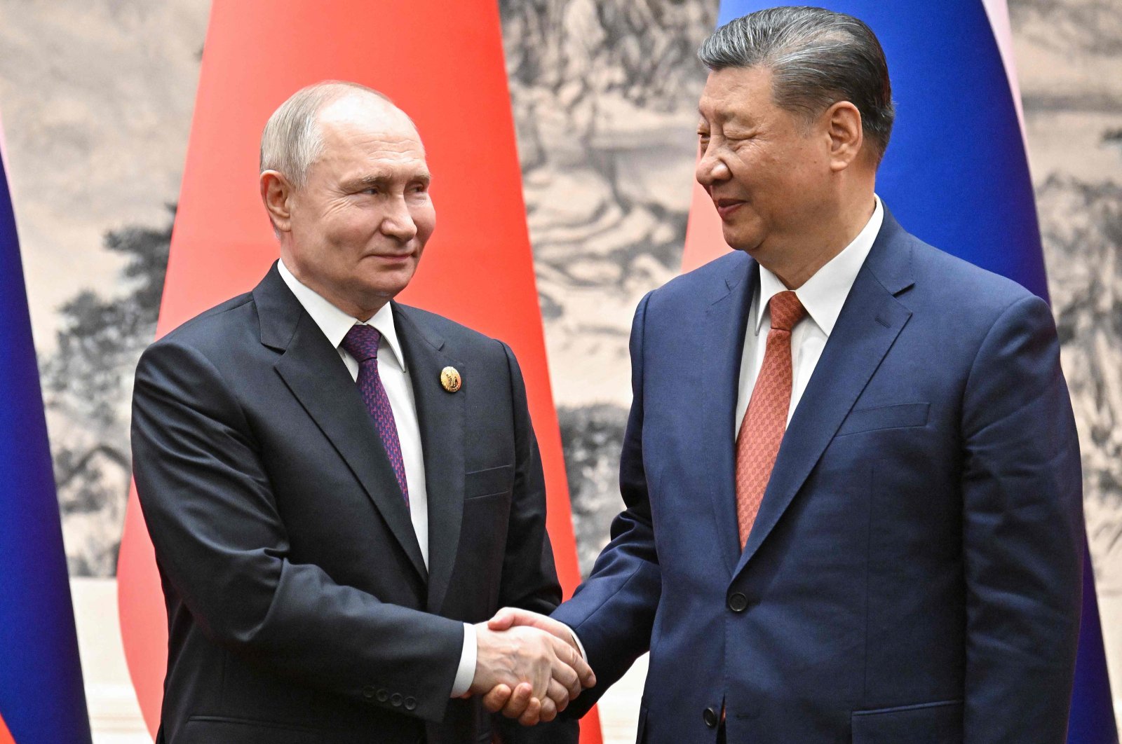 Russia&#039;s President Vladimir Putin (L) and China&#039;s President Xi Jinping shake hands in Beijing, China, May 16, 2024. (AFP Photo)