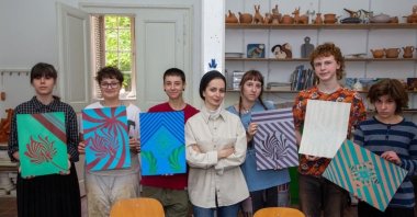 In this undated photo, Turkish artist Zeynep Çilek Çimen is seen with Croatian students holding their artwork, Zagreb, Croatia.  (Photo courtesy of Zeynep Çilek Çimen)