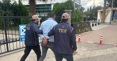 Police officers escort to the courthouse a suspect detained for spreading PKK propaganda, southern Adıyaman province, Türkiye, May 7, 2024. (AA Photo) 