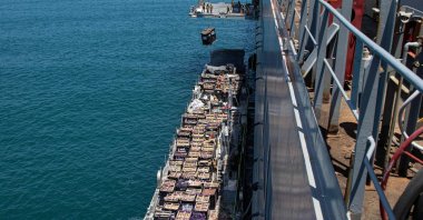 A humanitarian aid shipment is lifted by a crane operated by soldiers assigned to the 7th Transportation Brigade (Expeditionary) from a naval causeway at the Port of Ashdod, Israel, May 16, 2024. (AFP Photo)