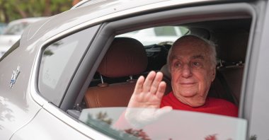 Former Gen. Çetin Doğan waves as he leaves prison, İzmir, western Türkiye, May 17, 2024. (AA Photo)