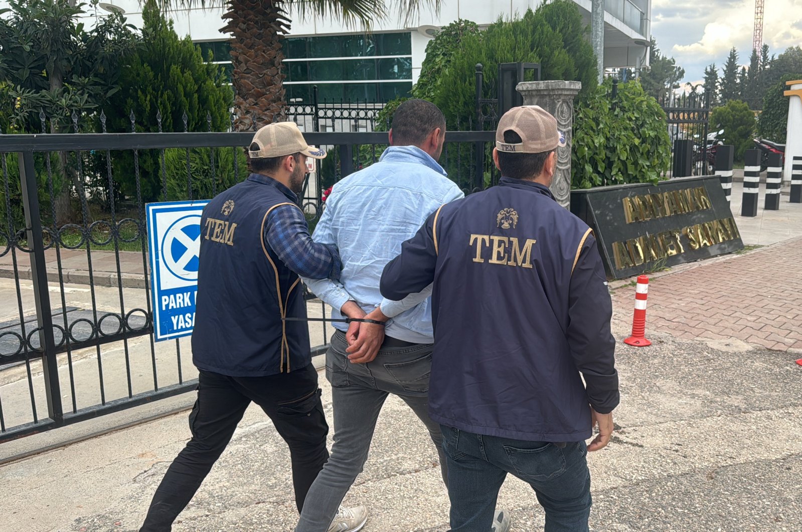 Police officers escort to the courthouse a suspect detained for spreading PKK propaganda, southern Adıyaman province, Türkiye, May 7, 2024. (AA Photo) 