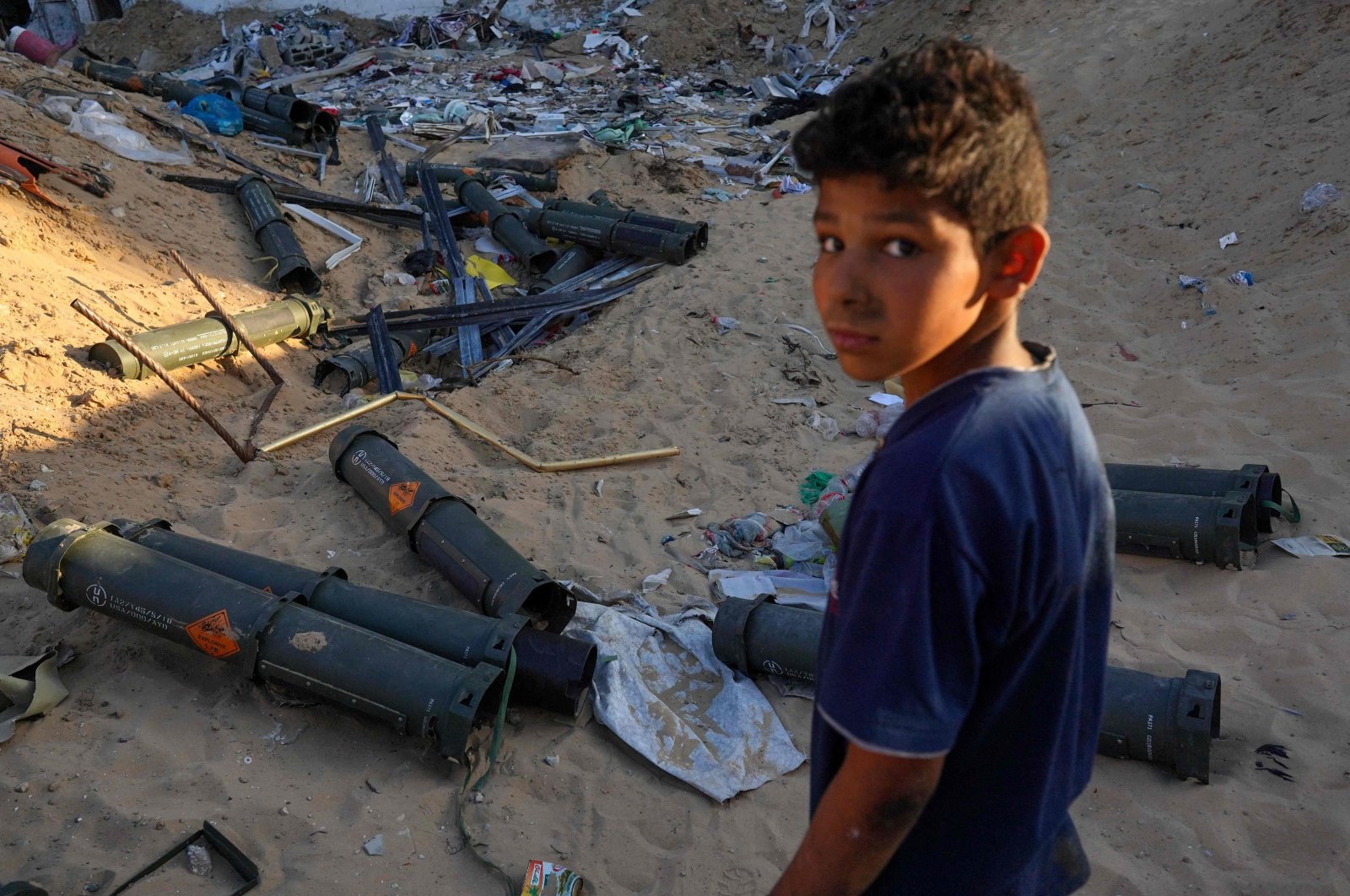 A Palestinian boy stands next to empty U.S. ammunition containers in Khan Yunis in the southern Gaza Strip, May 16, 2024. (AFP Photo)