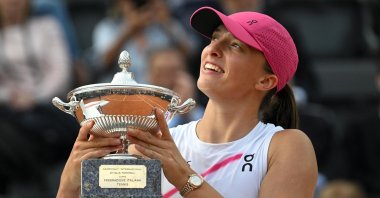 Iga Swiatek poses with her trophy after winning her women's final match against Aryna Sabalenka at the Italian Open, Rome, Italy, May 18, 2024. (EPA Photo)