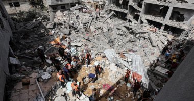 Palestinians inspect the site of an Israeli strike on a house at the al-Nuseirat refugee camp in central Gaza Strip, Palestine, May 19, 2024. (Reuters Photo)