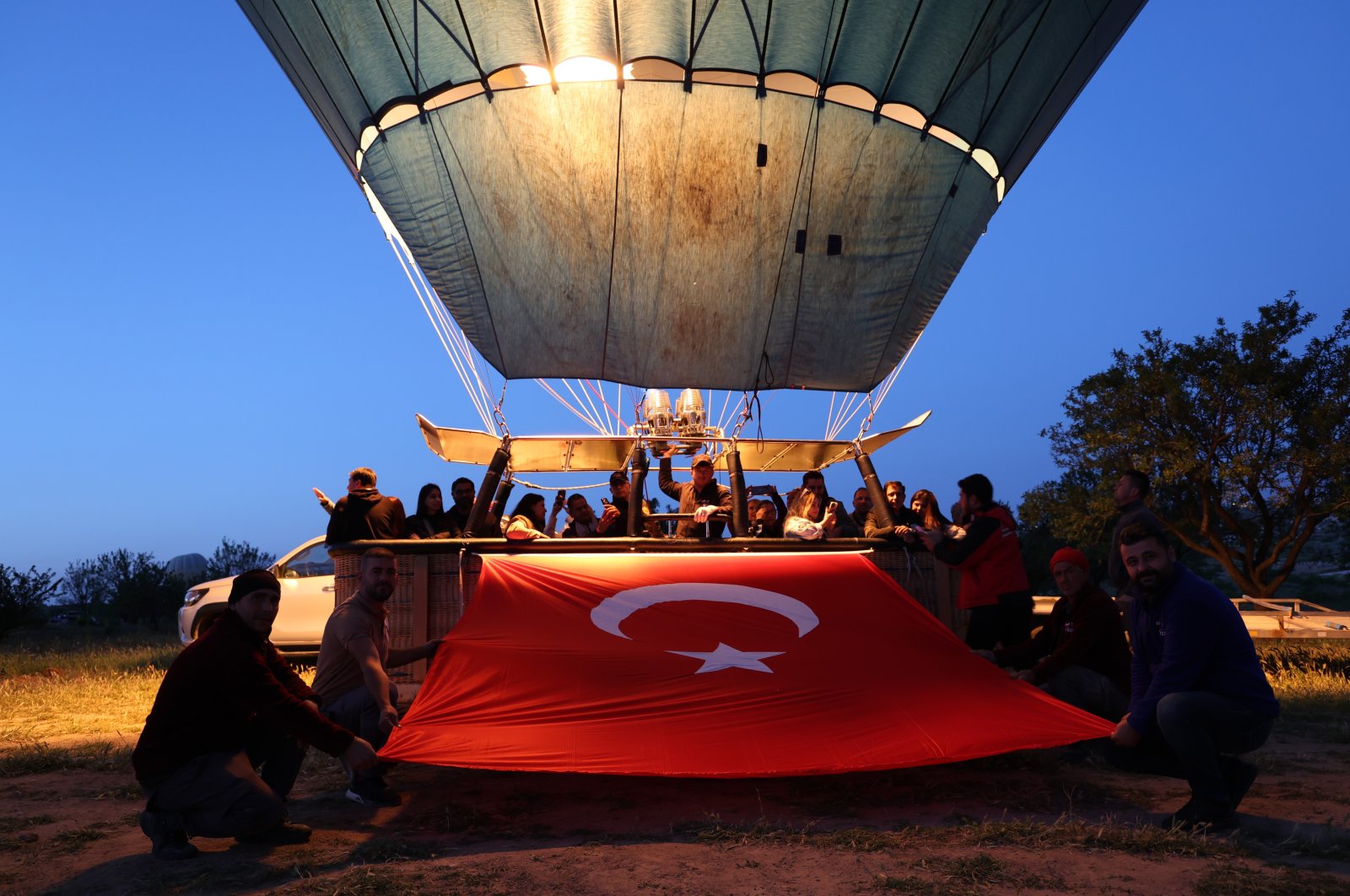 People celebrating May 19 board balloons and hold the Turkish flag, Cappadocia, Nevşehir, Türkiye, May 19, 2024. (İHA Photo)
