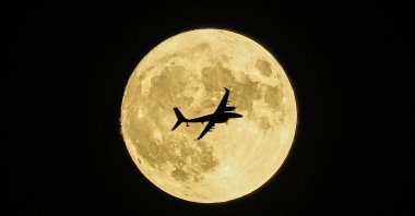An Akıncı UCAV passes in front of the supermoon during a demonstration flight, Ankara, Türkiye, Aug. 30, 2023. (AP Photo)