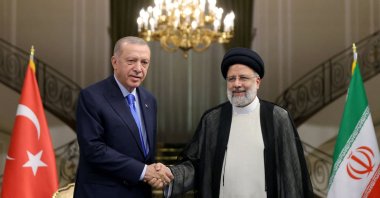 President Recep Tayyip Erdoğan (L) shakes hands with Iranian President Ebrahim Raisi, in Tehran, Iran, July 19, 2022. (AFP Photo)