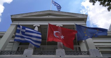 The Greek (L), Turkish (C) and European Union flags wave on the Greek Foreign Ministry house before a meeting of Turkish and Greek foreign ministers, Athens, Greece, May 31, 2021. (AP File Photo)