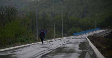 A Kosovo Serb woman crosses a bridge near the Serb-majority town of Zvecan, on April 21, 2024. (AFP Photo)