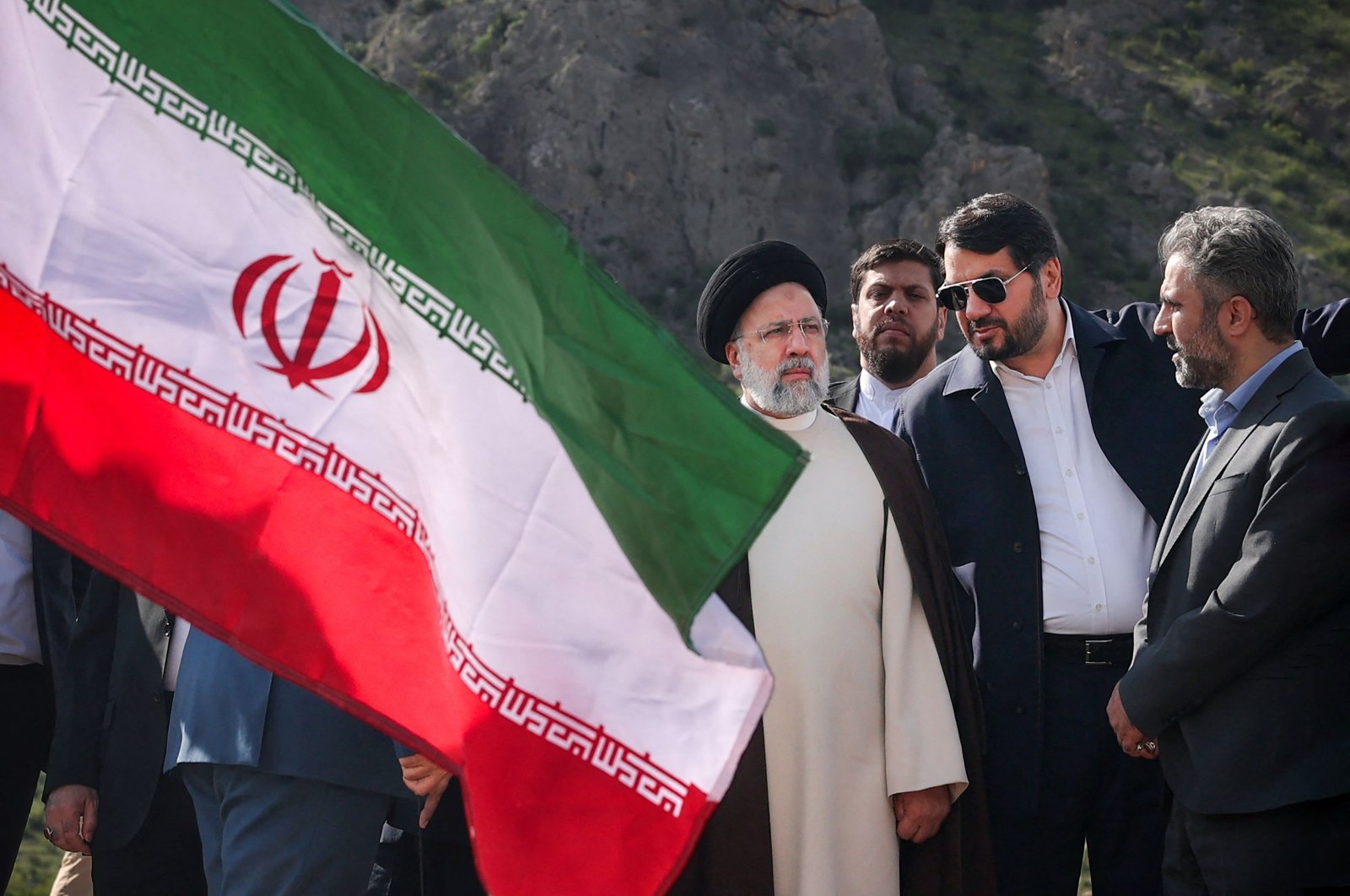 A handout picture provided by the Iranian Presidency shows Iranian President Ebrahim Raisi (C) at the site of Qiz Qalasi, the third dam jointly built by Iran and Azerbaijan on the Aras River, ahead of its inauguration ceremony, on the international border between Iran and Azerbaijan, May 19, 2024. (AFP Photo)