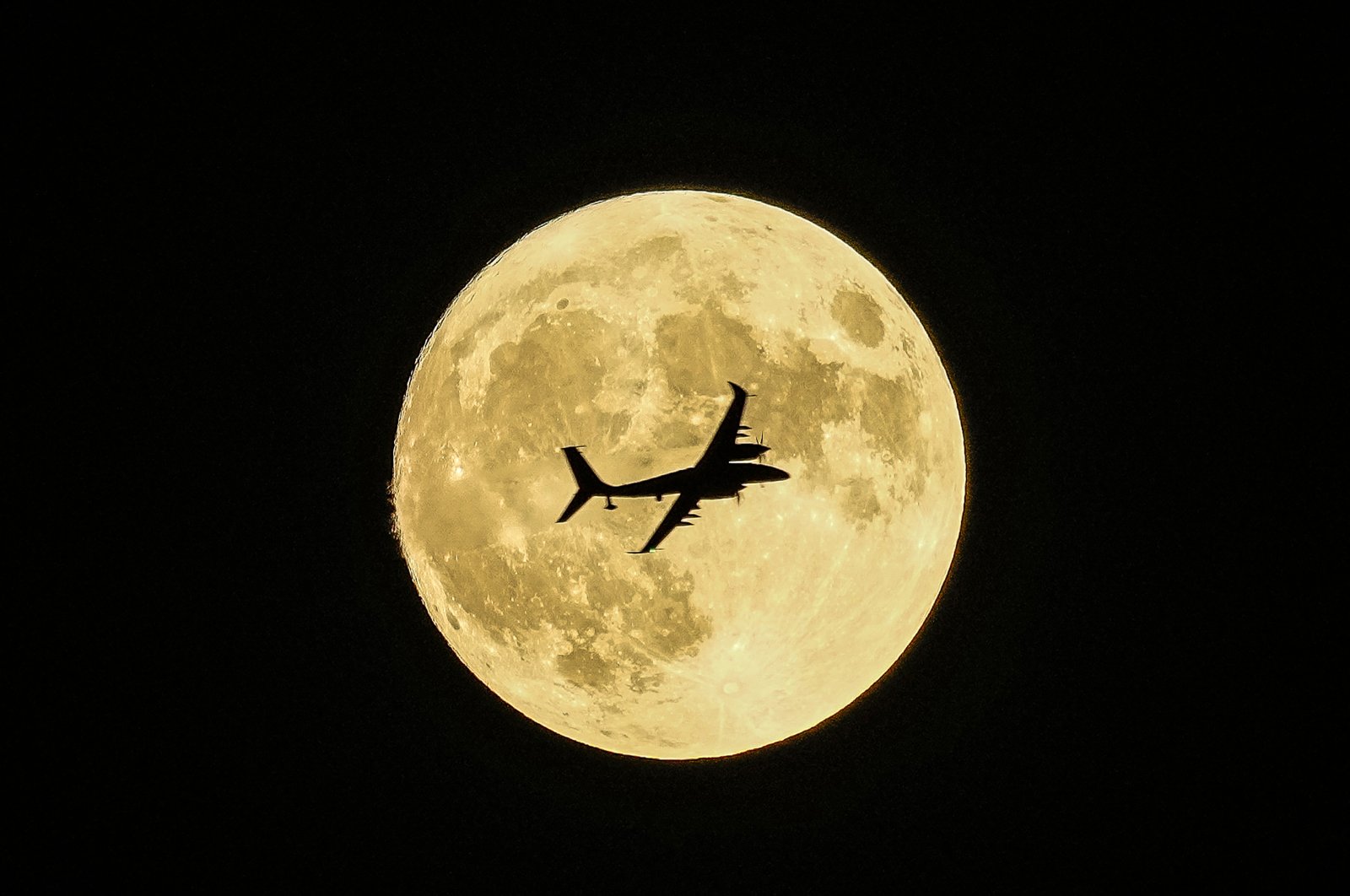 An Akıncı UCAV passes in front of the supermoon during a demonstration flight, Ankara, Türkiye, Aug. 30, 2023. (AP Photo)