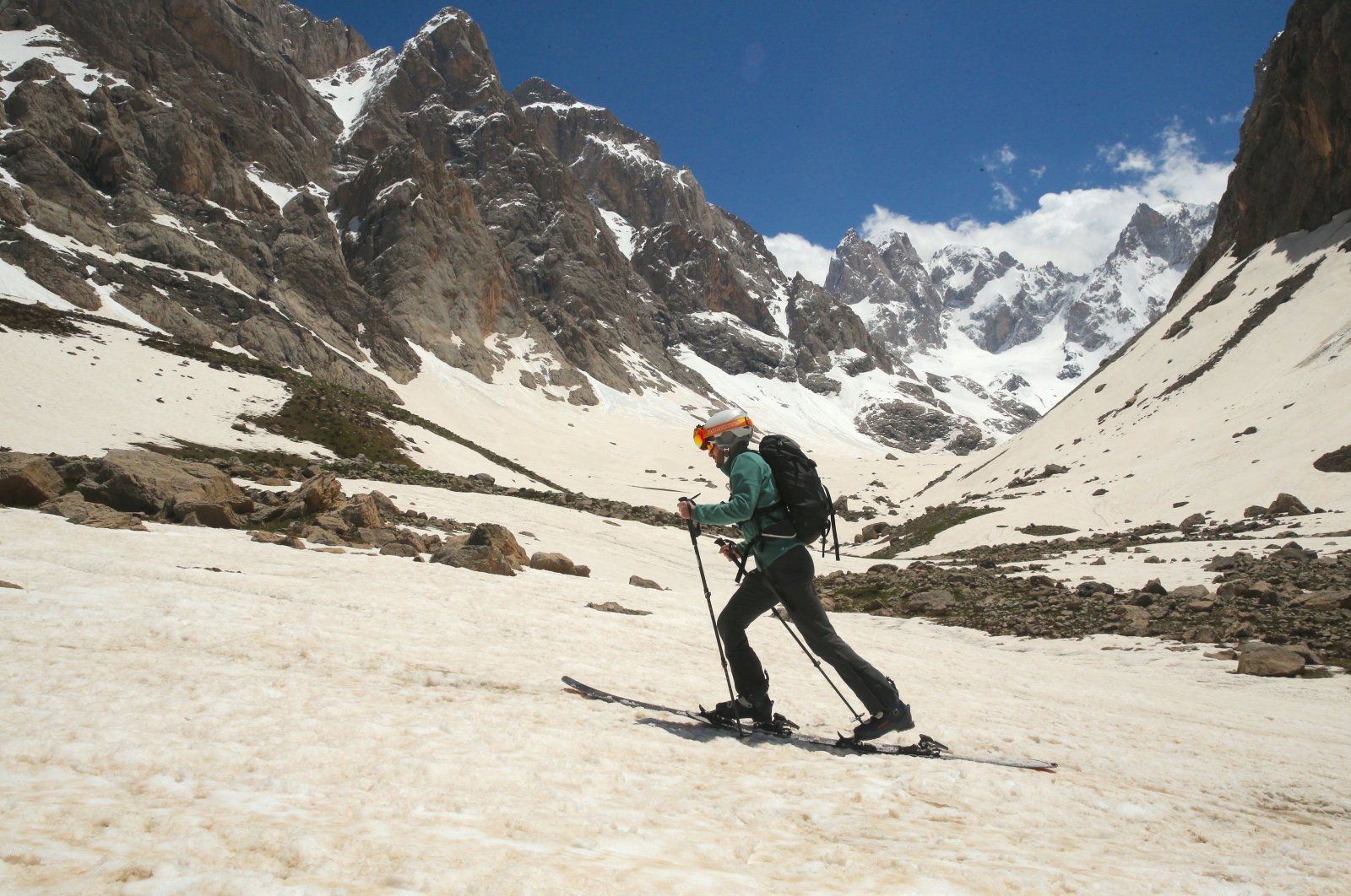 Athletes enjoy mountain skiing and snowboarding at the foot of the Cilo Mountains, Hakkari, Türkiye, May 19, 2024. (AA Photos)