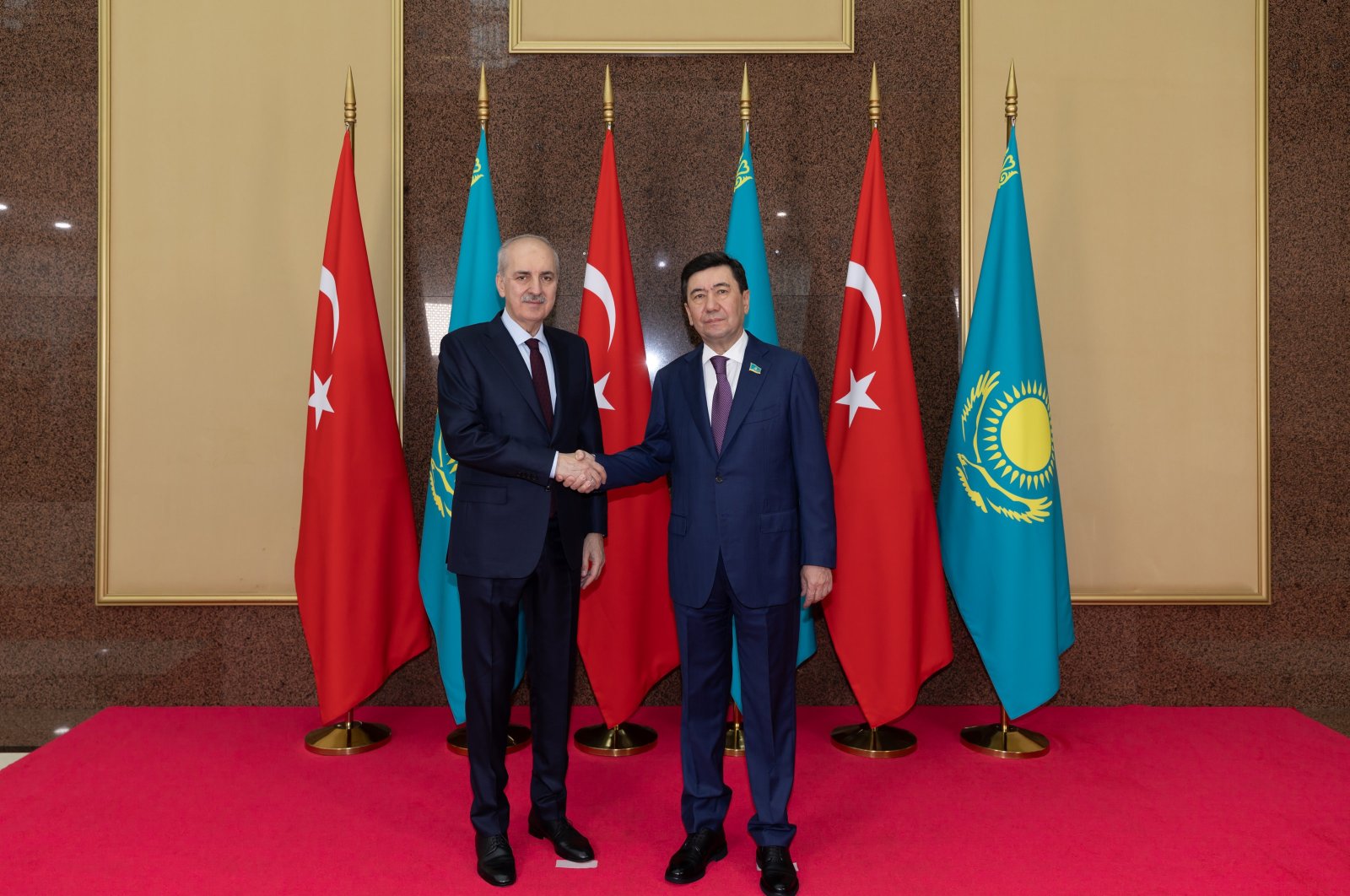 Parliament Speaker Numan Kurtulmuş (L) shakes hands with Erlan Qoshanov, Astana, Kazakhstan, May 20, 2024. (AA Photo)