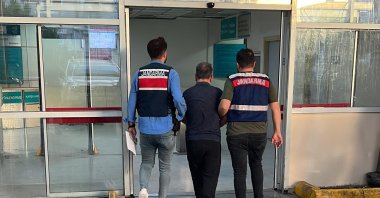 Gendarmerie officers escort a captured suspect in Izmir, western Türkiye, May 21, 2024. (İHA Photo)