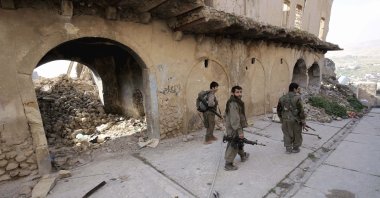 PKK terrorists walk on the streets of Sinjar, Iraq, Jan. 29, 2015. (AP Photo)