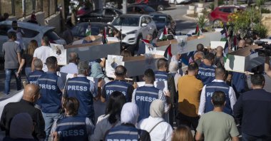 Palestinian journalists carry mock coffins of Palestinian journalists who were killed by Israel in Gaza during a symbolic funeral toward a United Nations office, in the West Bank city of Ramallah, Tuesday, Nov. 7, 2023. (AP File Photo)