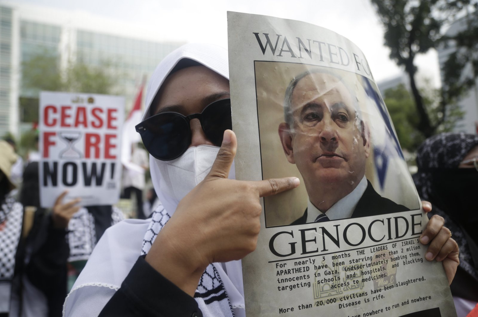 Indonesian activists hold a banner reading &quot;ceasefire now&quot; and a picture of Israeli leader Prime Minister Benjamin Netanyahu reading &quot;wanted for genocide&quot; as they stage a protest in Jakarta, Indonesia, May 17, 2024. (EPA Photo)