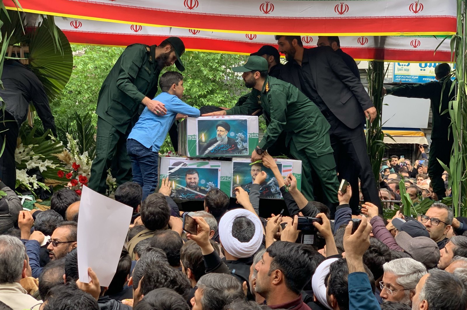 People attend a funeral ceremony for the victims of a helicopter crash that killed Iranian President Ebrahim Raisi in Tabriz, East Azerbaijan Province, Iran, May 21, 2024. (AA Photo)