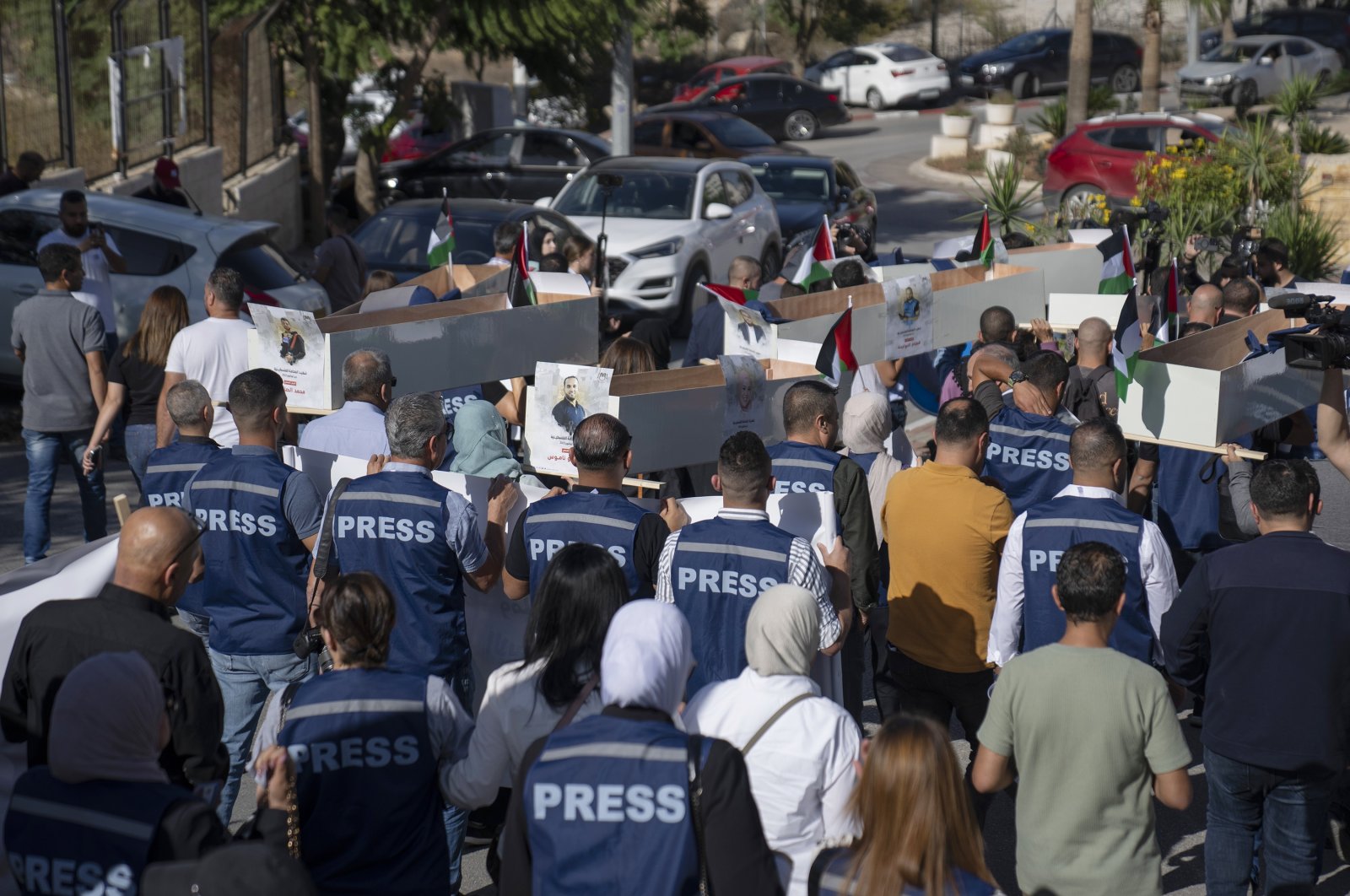 Palestinian journalists carry mock coffins of Palestinian journalists who were killed by Israel in Gaza during a symbolic funeral toward a United Nations office, in the West Bank city of Ramallah, Tuesday, Nov. 7, 2023. (AP File Photo)