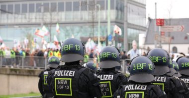 Police officers watch a demonstration by supporters of the PKK terrorist group, Cologne, Germany, Feb. 17, 2024. (Reuters Photo)
