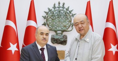Director of Gimhae National Museum, Yun Hyeung-won, presents a Gimhae National Museum catalog and a gift to Governor Zülkif Dağlı, Çorum, Türkiye, May 21, 2024. (IHA Photo)