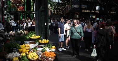 People walk past fruit and vegetable stalls at Borough Market, London, U.K., May 10, 2024. (AFP Photo)
