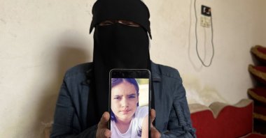 Selma Abdo shows the photo of her daughter kidnapped by the PKK/YPG terrorist organization, Hassakeh, Syria, April 25, 2024. (AA Photo)