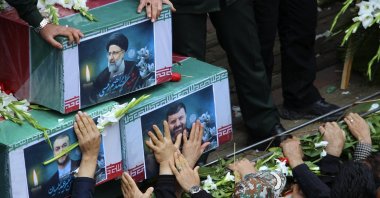 Mourners try to touch the coffins of Iranian President Ebrahim Raisi (top), Foreign Minister Hossein Amirabdollahian (L) and Raisi&#039;s chief bodyguard Gen. Mehdi Mousavi, who were killed in a helicopter crash on Sunday in a mountainous region of the country&#039;s northwest, during a funeral ceremony in the city of Tabriz, Iran, May 21, 2024. (AP Photo)