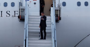 France's President Emmanuel Macron waves as he boards his Presidential plane to travel to the Pacific archipelago of New Caledonia, Paris, France, May 21, 2024. (Reuters Photo)