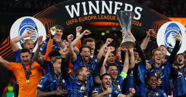 Atalanta's Berat Djimsiti lifts the trophy as he celebrates with teammates after winning the Europa League against Bayer Leverkusen, Aviva Stadium, Dublin, Ireland, May 22, 2024. (Reuters Photo)