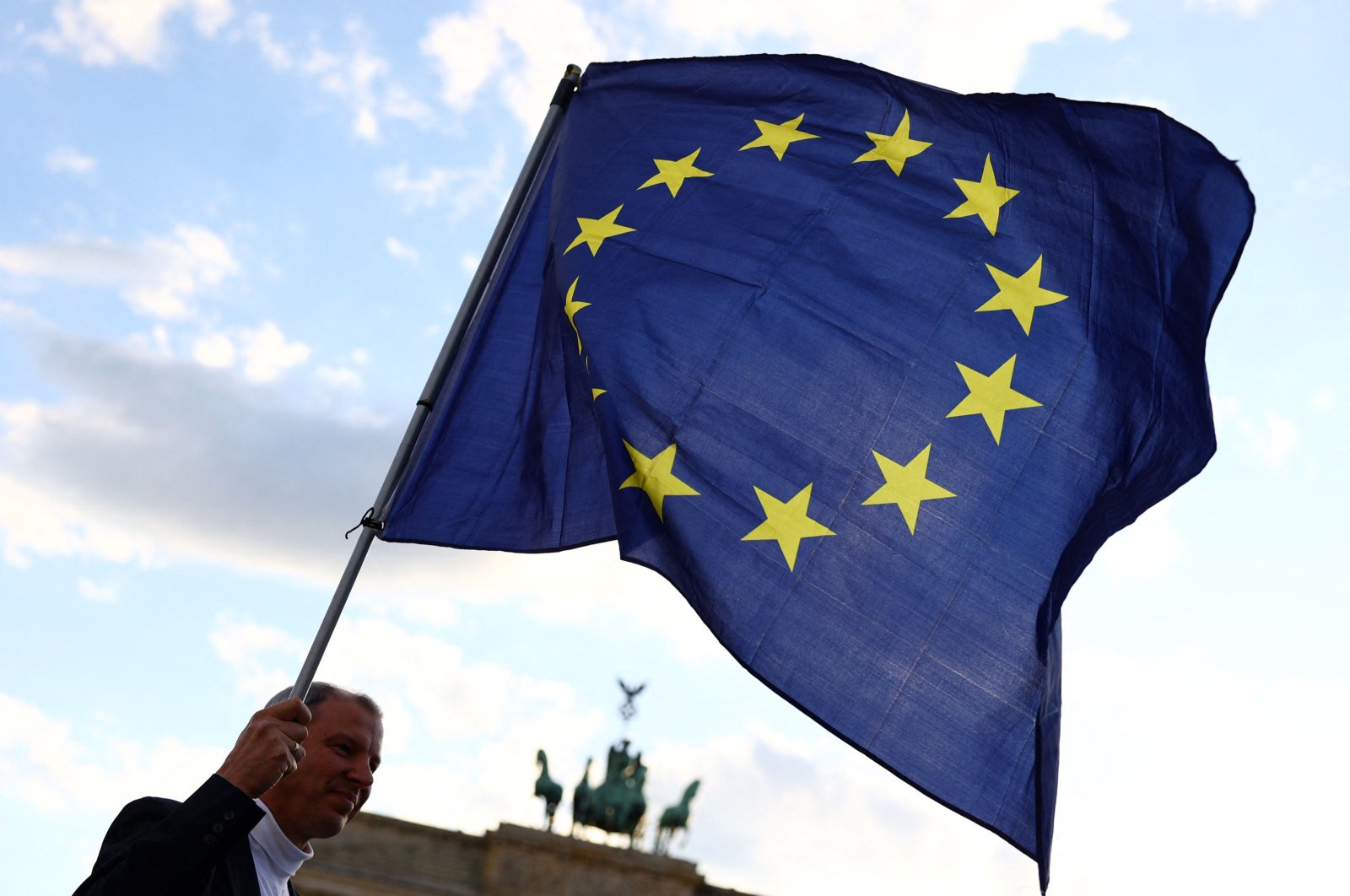 A participant displays the flag of the European Union during a demonstration against the far right and to condemn attacks on politicians, in front of the Brandenburg Gate, Berlin, Germany, May 5, 2024. (AFP Photo)