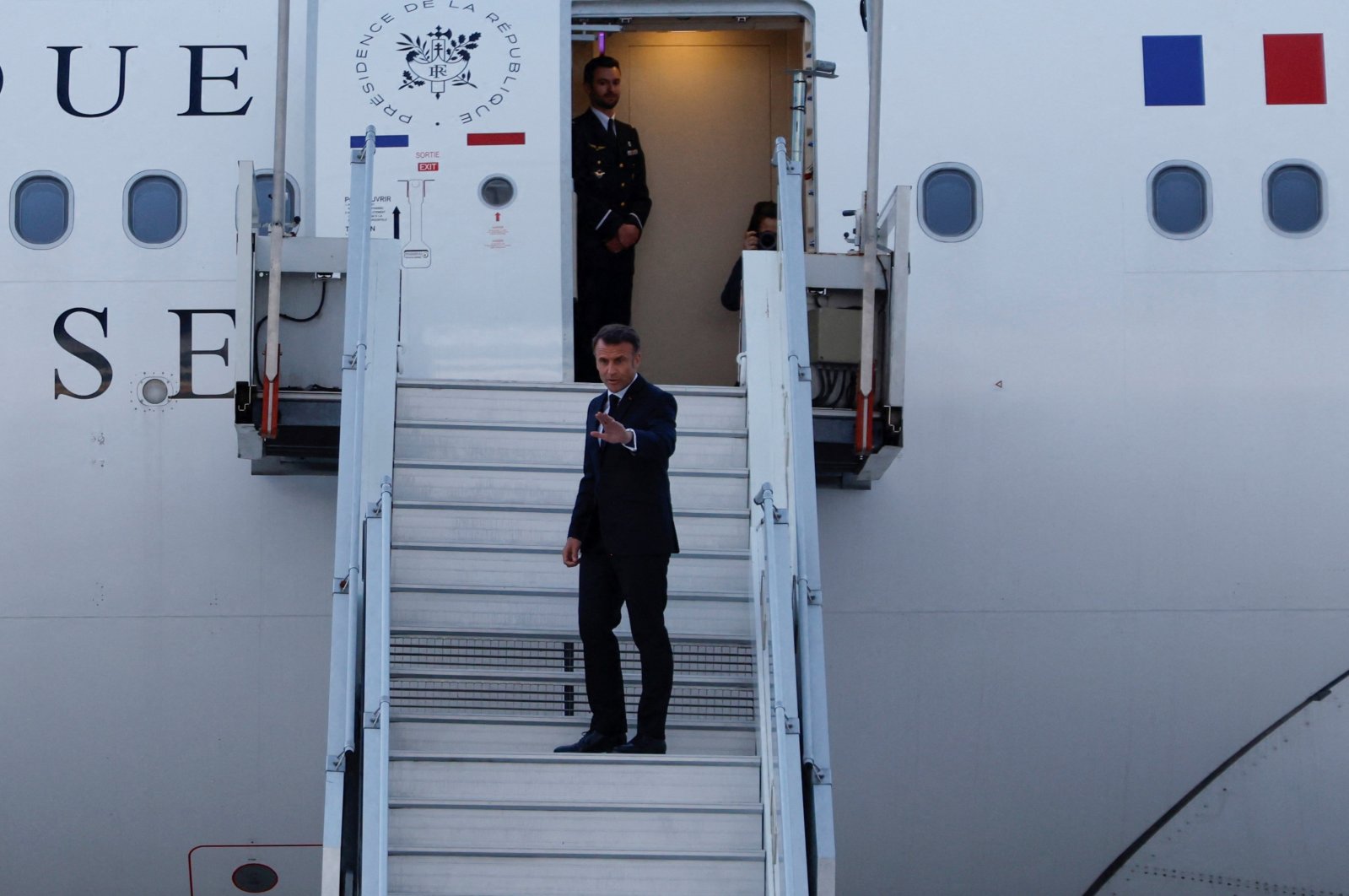 France&#039;s President Emmanuel Macron waves as he boards his Presidential plane to travel to the Pacific archipelago of New Caledonia, Paris, France, May 21, 2024. (Reuters Photo)