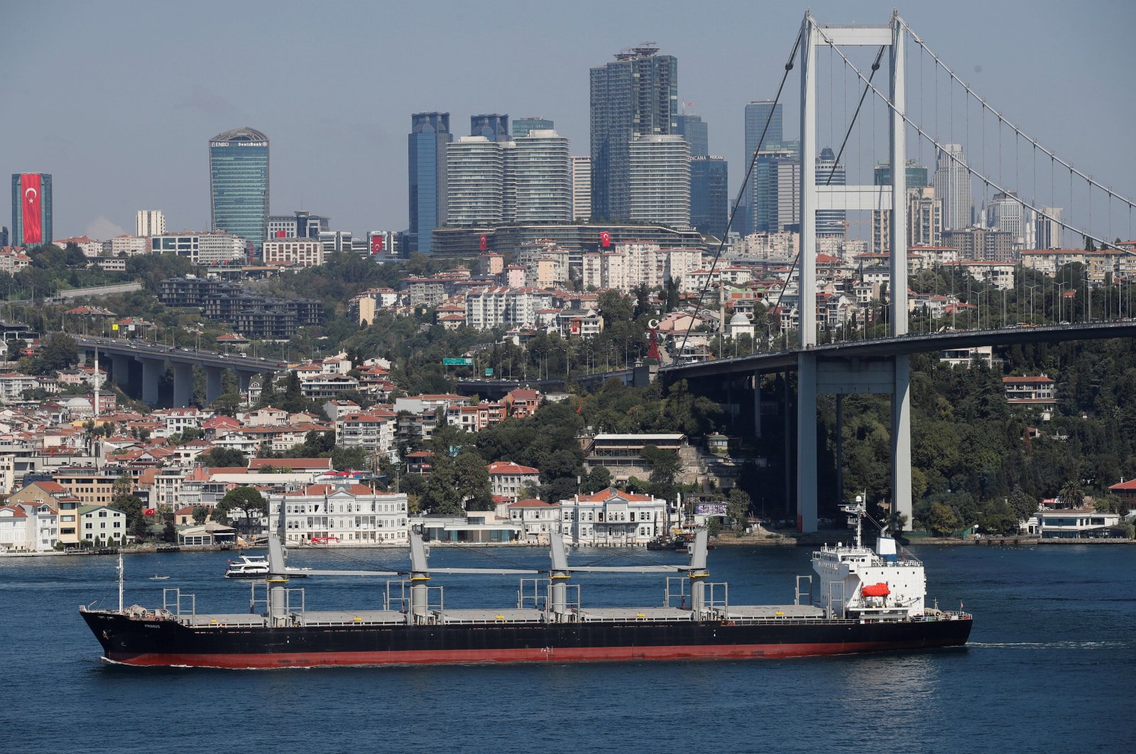 A bulk carrier transits Bosporus on its way to the Mediterranean Sea with skyscrapers in the background in Istanbul, Türkiye, Aug. 29, 2023. (Reuters Photo)