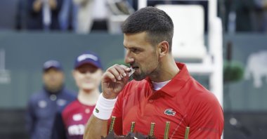 Serbia's Novak Djokovic tastes his birthday cake after he won his second round match of the ATP 250 Geneva Open tennis tournament against Germany's Yannick Hanfmann, Geneva, Switzerland, May 22, 2024. (AP Photo)