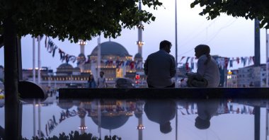 A couple sit in a public bench at Taksim square in Istanbul, Türkiye, May 22, 2024. (AP Photo)