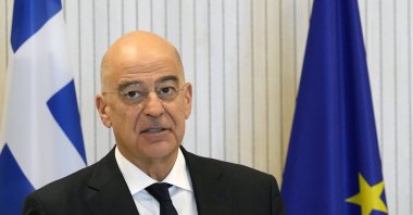 Greek politician Nikos Dendias talks to the media during a news conference in Greek Cyprus, March 31, 2023. (AP File Photo)