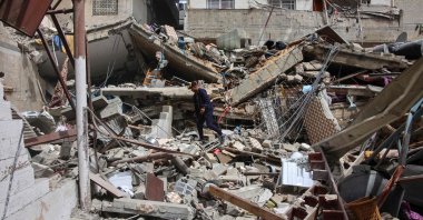 A Palestinian searches through debris at the site of an Israeli strike on the Al-Daraj neighborhood in Gaza City on May 23, 2024. (AFP Photo)