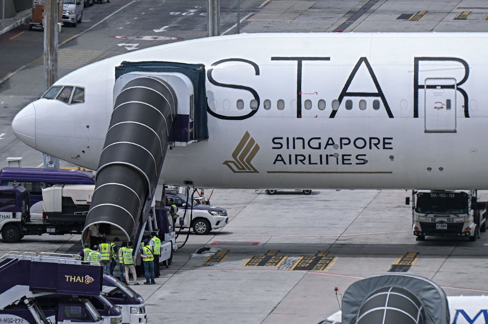 Officials enter the Singapore Airlines Boeing 777-300ER airplane, which was headed to Singapore from London before making an emergency landing in Bangkok due to severe turbulence, as it is parked on the tarmac at Suvarnabhumi International Airport in Bangkok, Thailand, May 22, 2024. (AFP Photo)