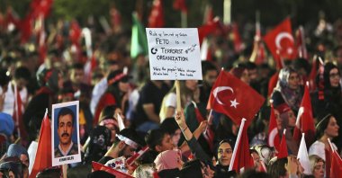 People hold placards denouncing FETÖ in a rally to mark the anniversary of the foiled coup attempt, in the capital Ankara, Türkiye, July 16, 2017. (AP Photo)