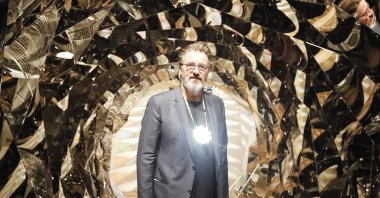 Olafur Eliasson poses at the installation &quot;Your Spiral View&quot; as part of the exhibition Olafur Eliasson: &quot;In real life&quot; at the Tate Modern Gallery in London, U.K., July 9, 2019. (AP Photo)