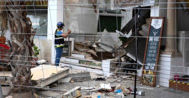 A Police officer takes images during investigation works a day after a two-storey restaurant collapsed, on Playa de Palma, Spain, May 24, 2024. (AFP Photo)