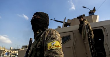 A YPG/PKK-dominated SDF terrorist stands guard in Raqqa, Syria, on Feb. 7, 2022. (AP File Photo)