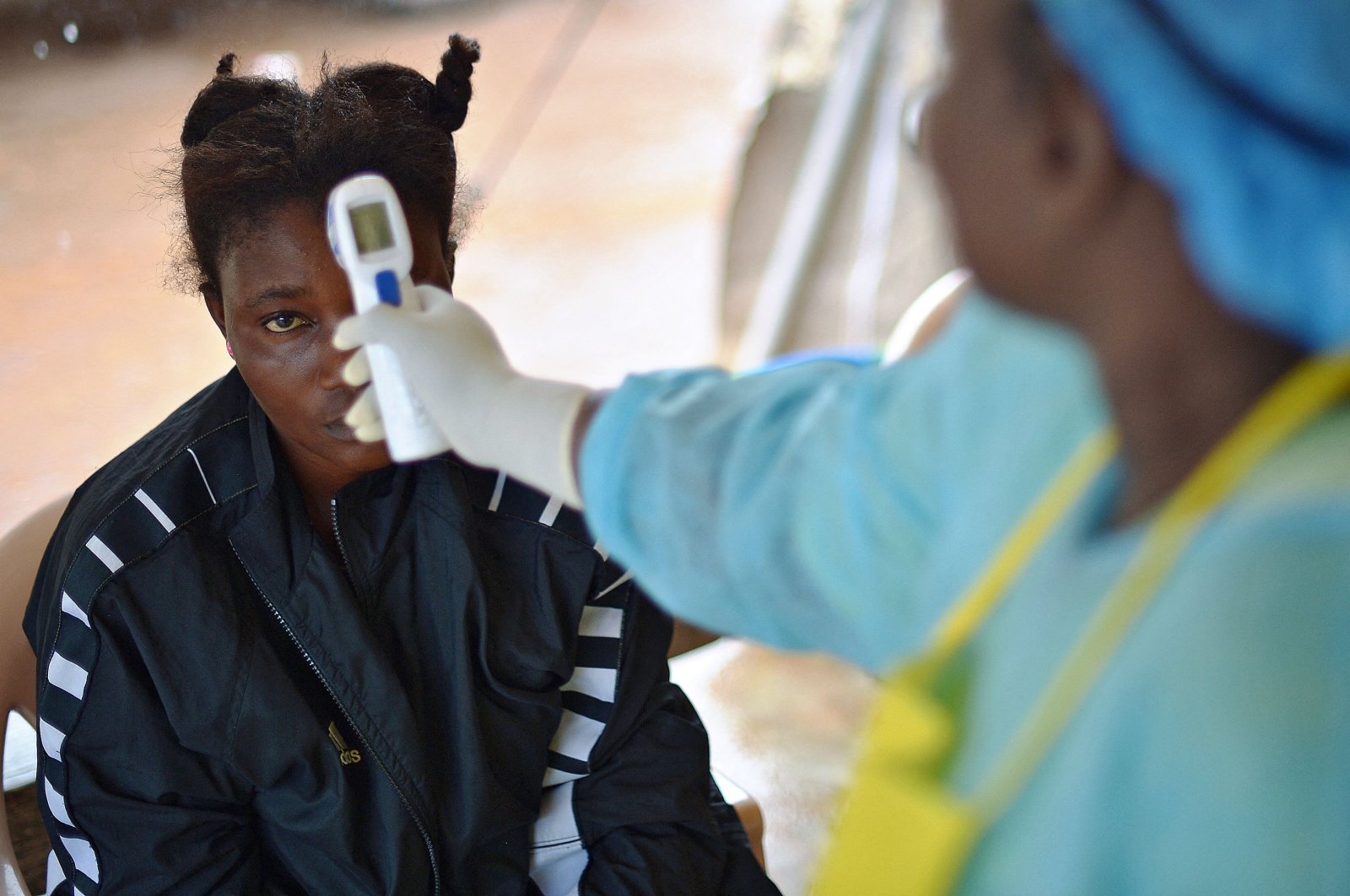 A girl suspected of being infected with the Ebola virus has her temperature checked at the government hospital in Kenema, Sierra Leone, Aug. 16, 2014. (AFP Photo)