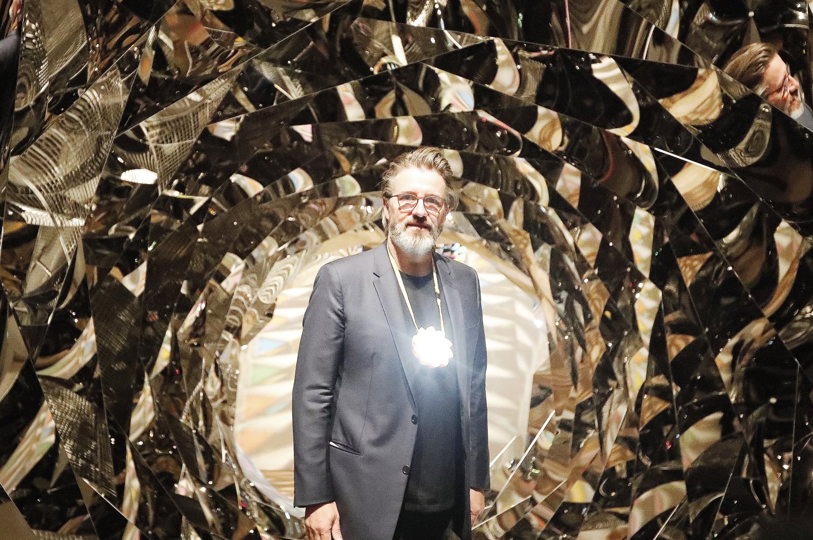 Olafur Eliasson poses at the installation &quot;Your Spiral View&quot; as part of the exhibition Olafur Eliasson: &quot;In real life&quot; at the Tate Modern Gallery in London, U.K., July 9, 2019. (AP Photo)